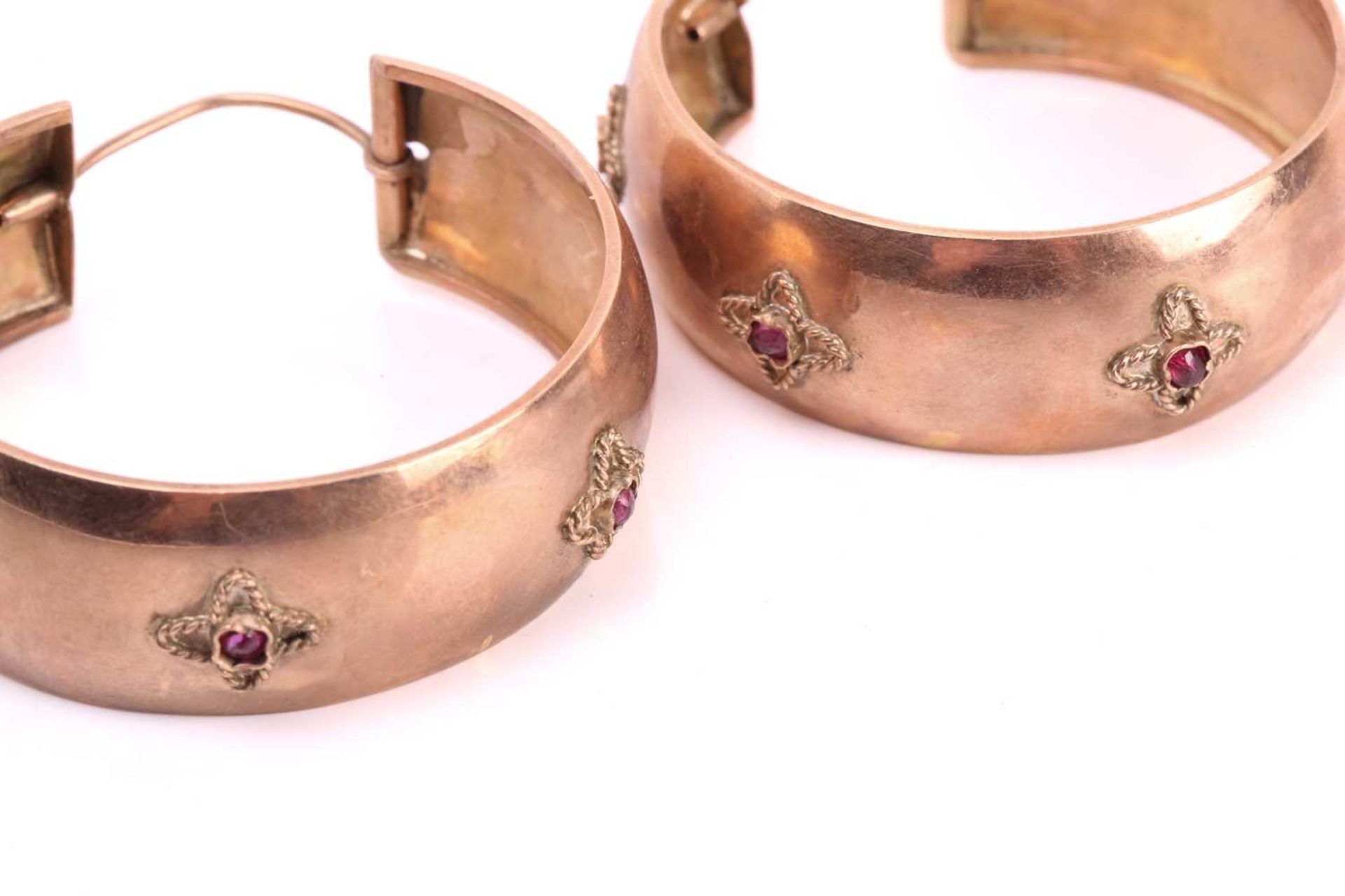 A pair of large hoop earrings set with rubies within a flower motif, each earring measuring - Image 4 of 4