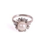 A pearl and diamond dress ring, centred with a round cultured pearl of 8.2 mm, in white colour and