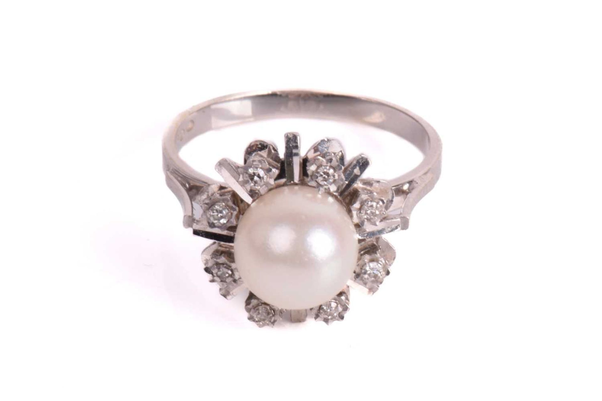 A pearl and diamond dress ring, centred with a round cultured pearl of 8.2 mm, in white colour and