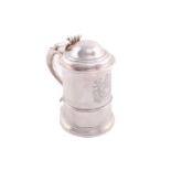 A George II silver tankard with straight sided tapering body and domed hinged cover with a chairback
