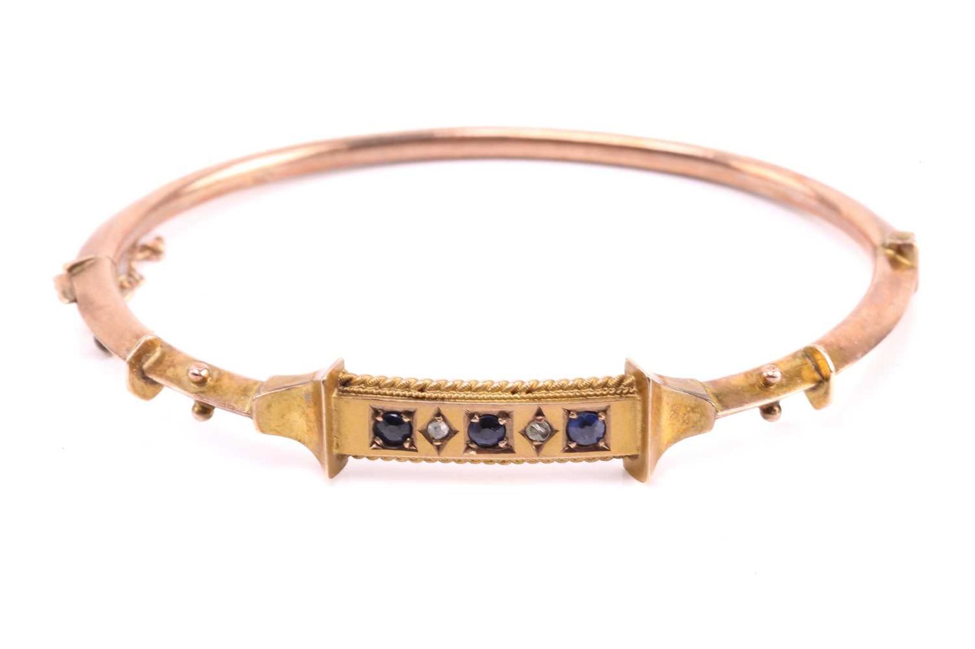 A Victorian hinged bracelet set with blue paste and diamond, the bangle centred with a curved