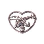 Georg Jensen - a 'double dolphin' brooch, depicting two dolphins leaping over a sea shell with a