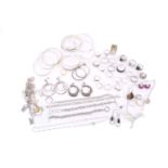 A collection of mixed white metal jewellery, including examples of a silver hinged bracelet, half of
