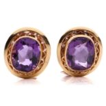 A pair of amethyst earrings, each consisting of an oval-cut amethyst, approximately measures 11.4