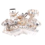 A large quantity of silver plate including entree dishes, muffin dishes a tea kettle on stand, a tea