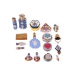 A small collection of Victorian and later perfume bottles including a white metal capped Wedwood for
