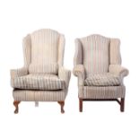 Two George III style wing armchairs, 20th century, each well upholstered in a striped material,