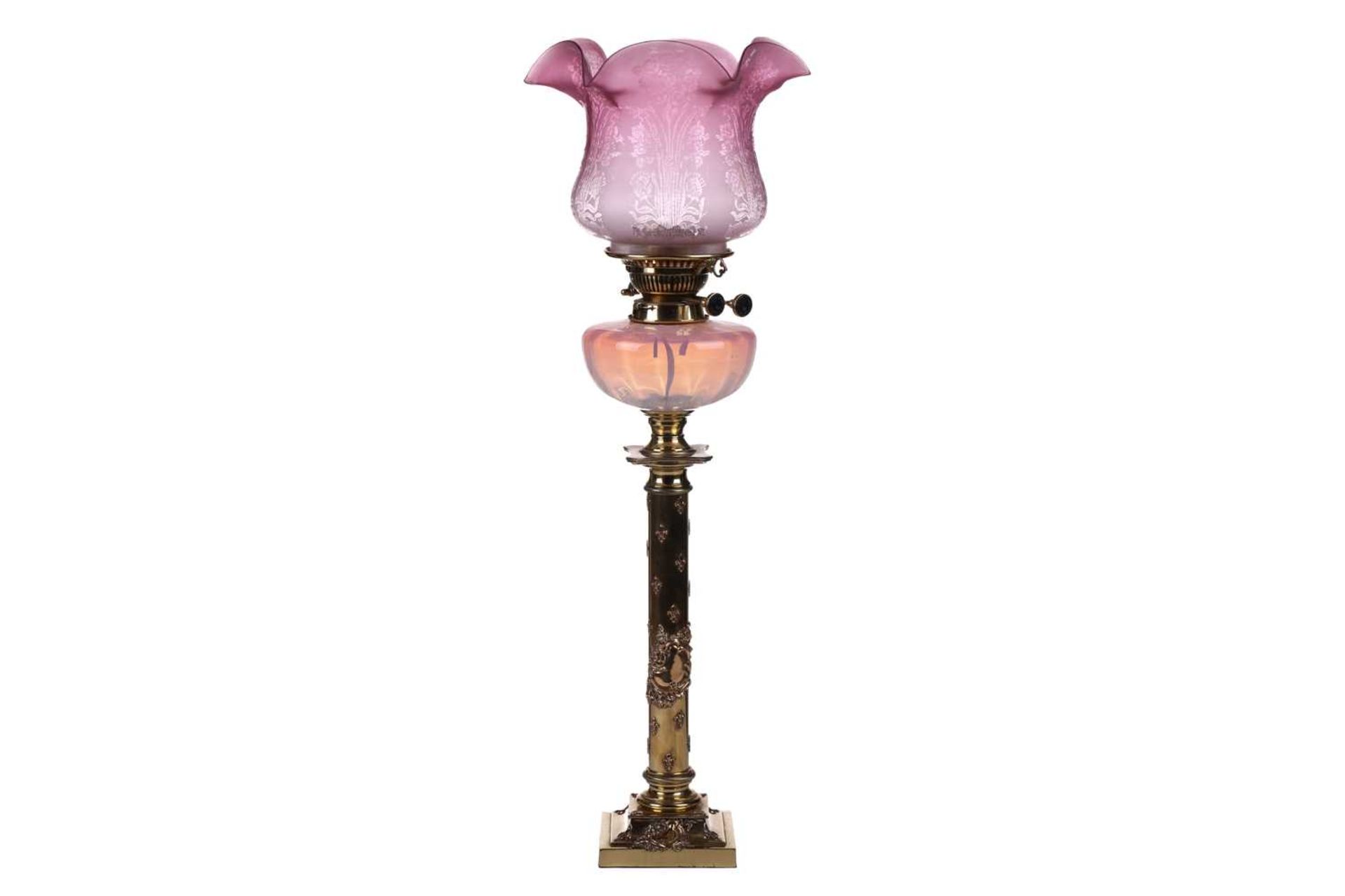 A Victorian brass oil lamp with vaseline and cranberry glass reservoir and diffuser (now fitted