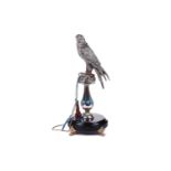 Lorenzo Sandomar, a large model of a silver and gold plated falcon, marked 925, standing on a