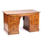 An "Estate Made" solid walnut kneehole writing desk, early 20th century, fitted six short drawers on