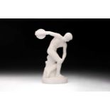 A classical white carved alabaster figure of "The Discobolus" after Myron, on an oval socle base, 29