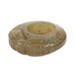 A Chinese carved green/yellow jade pendant ring in the form of a pair of scaley pig dragons