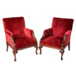 A pair of 19th-century-style scroll-backed fireside armchairs with crimson velvet stuff over