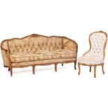 A Louis XV-style carved beechwood canape with floral cresting and channelled outline, on slender