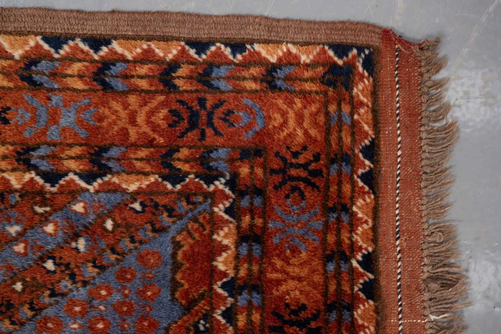 A large brick red/brown ground Qashqai rug with blue St. Andrew's cross filled diamond pattern - Image 2 of 8