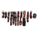 A good collection of late 18th and 19th century treen snuff boxes, in the form of boots and shoes,