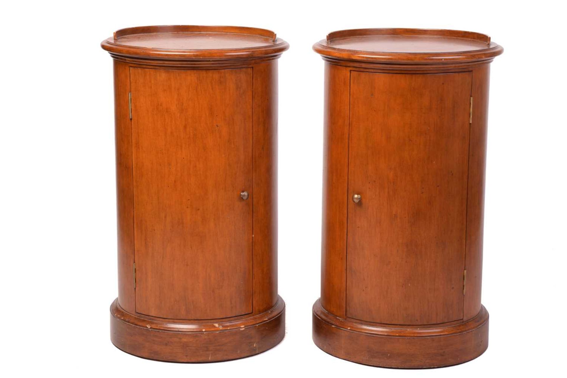 A pair of Victorian style mahogany cylinder pot cupboards, 20th century, with part blind gallery
