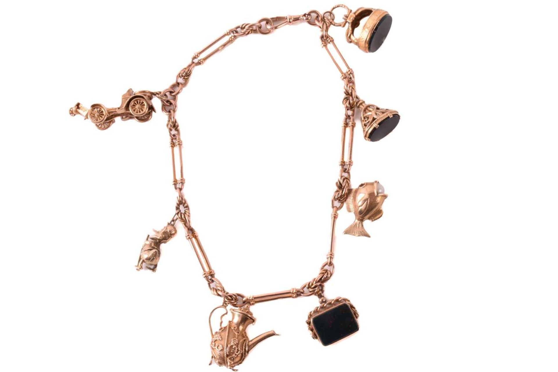 A 9ct rose gold watch chain with charms, comprising a trombone link chain terminated with a swivel