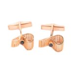 Kutchinsky - a pair of 18ct yellow gold cufflinks set with sapphires, of undulating ribbon design,