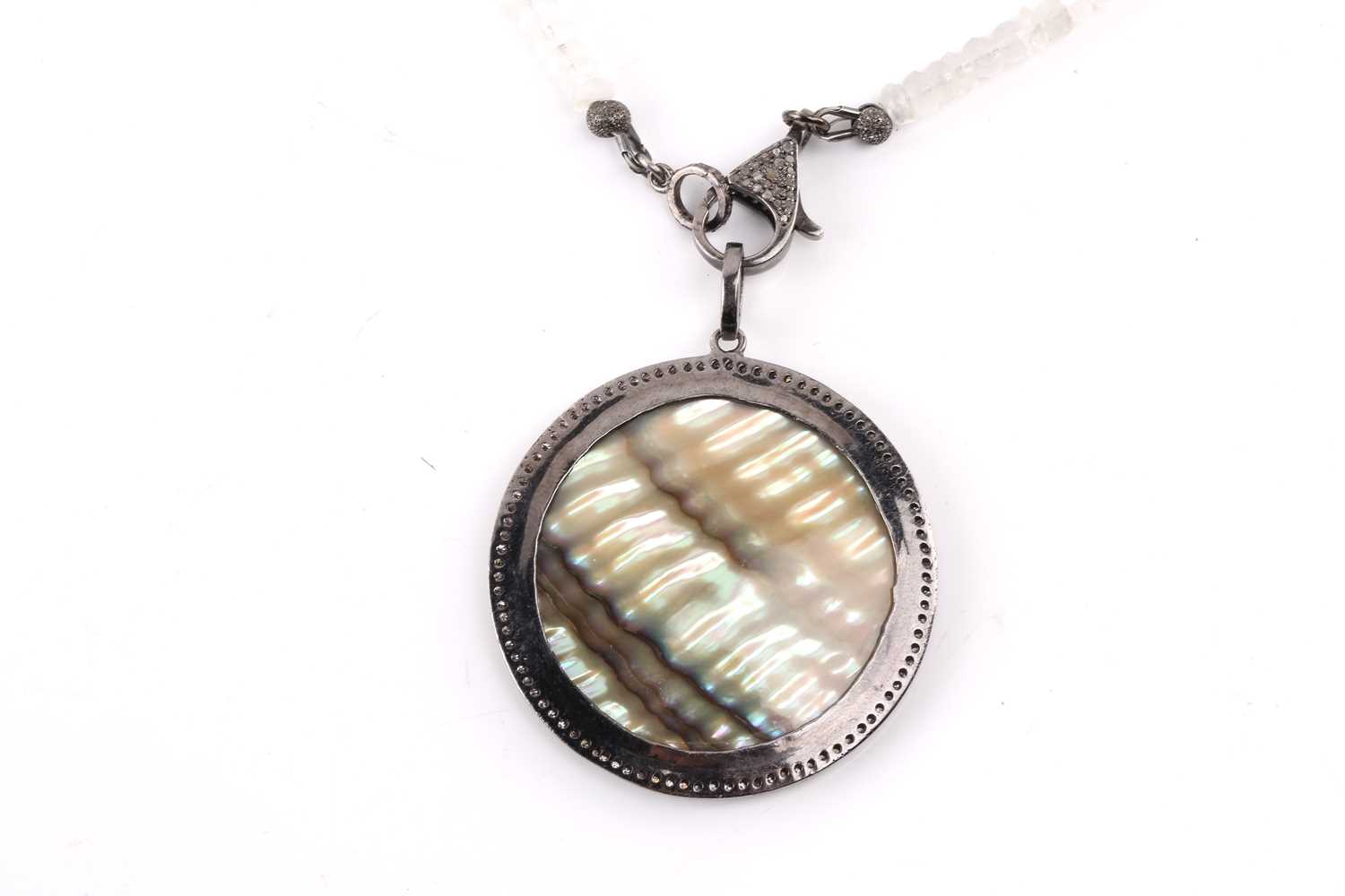 A diamond and mother of pearl pendant, the central polished circle of mother of pearl surrounded - Image 3 of 4