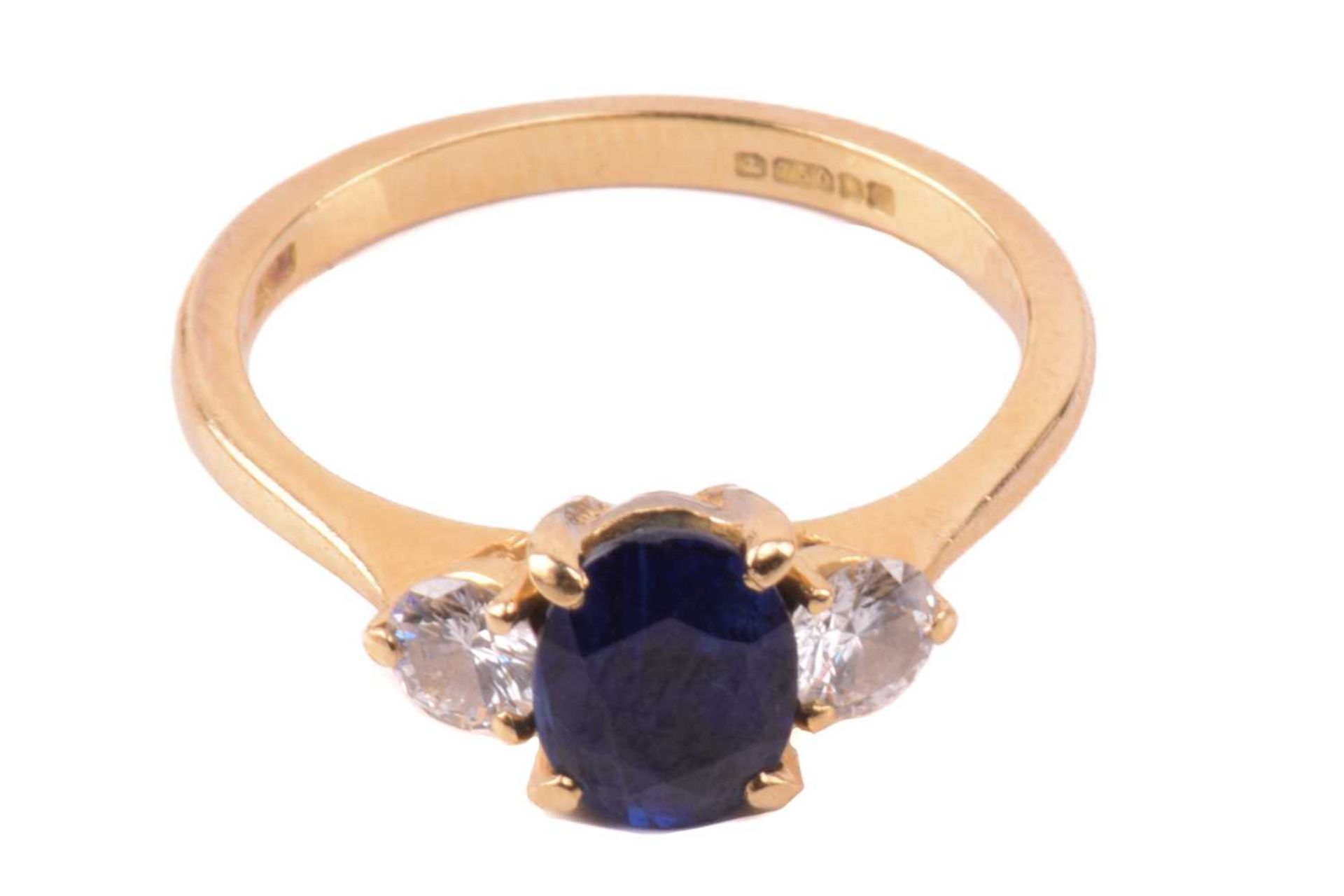 A Boodle & Dunthorne sapphire and diamond three stone ring, set with a central oval sapphire - Image 3 of 6