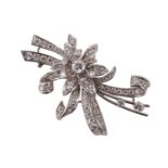 A diamond floral brooch by Cropp and Farr, circa 1961, the flower and sculptural ribbon design set