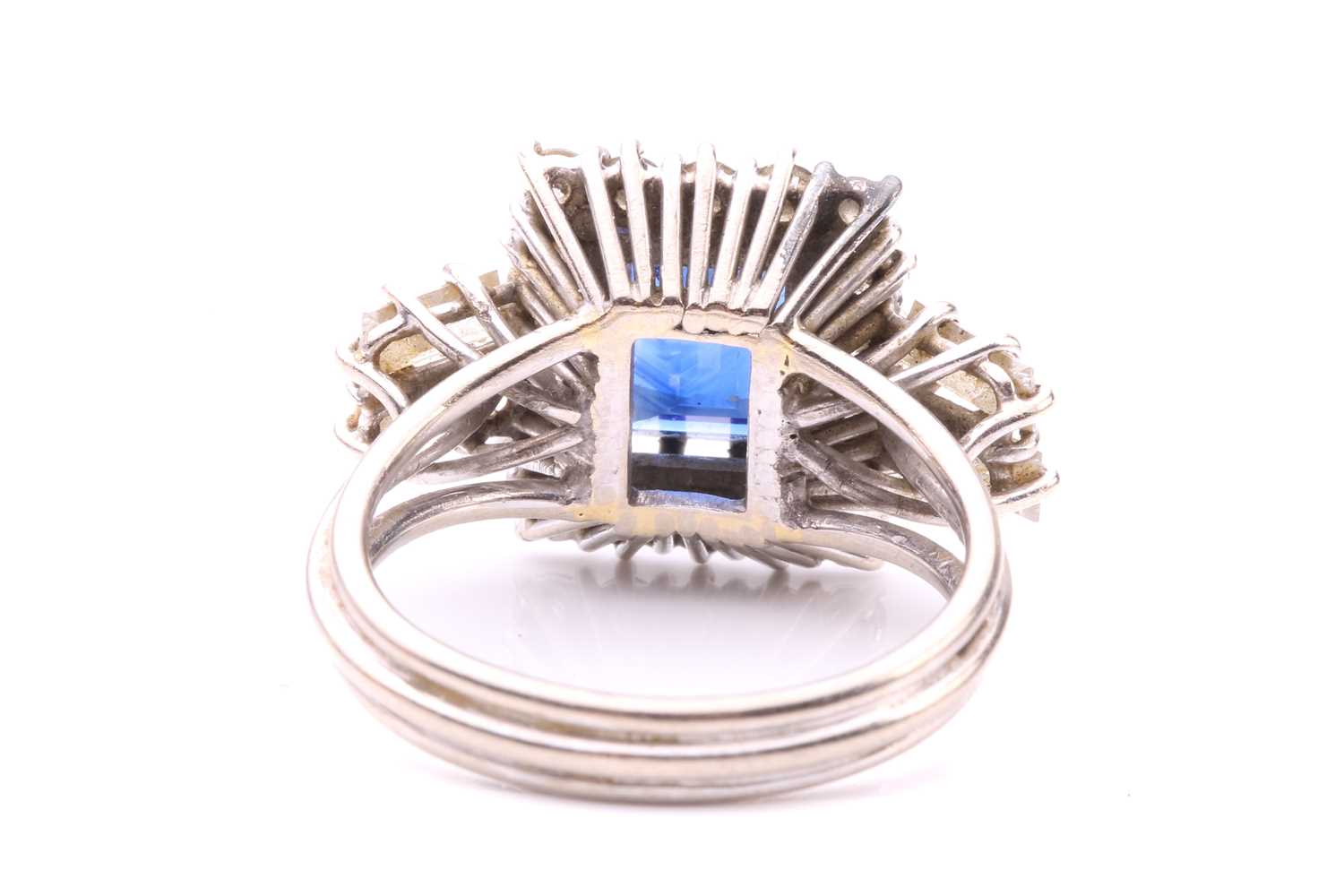 A sapphire and diamond entourage ring, featuring a rectangular step-cut sapphire of deep blue - Image 4 of 4