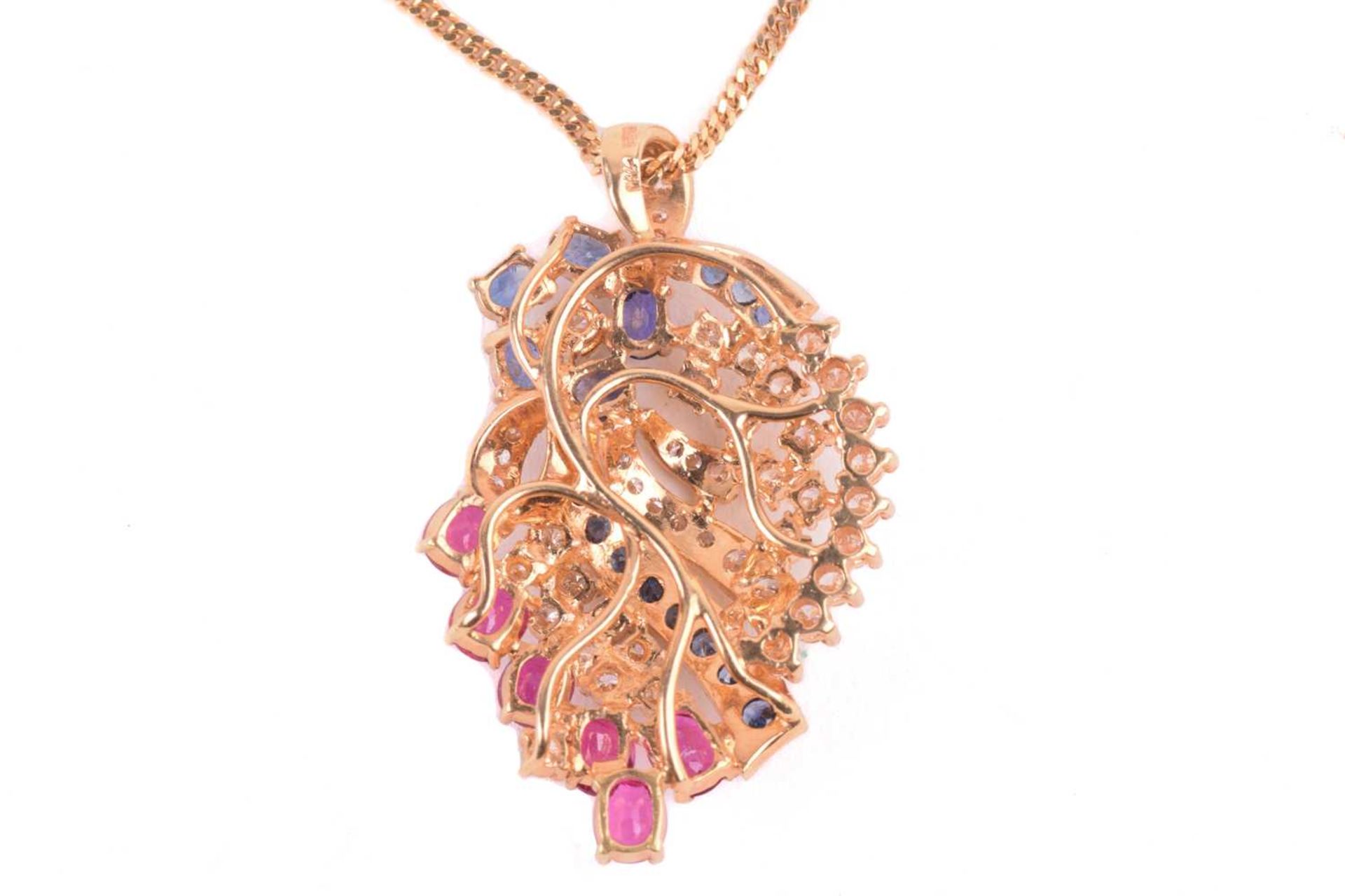 A diamond, ruby and sapphire spray pendant on chain; the stylised spray comprising a six stone - Image 4 of 4