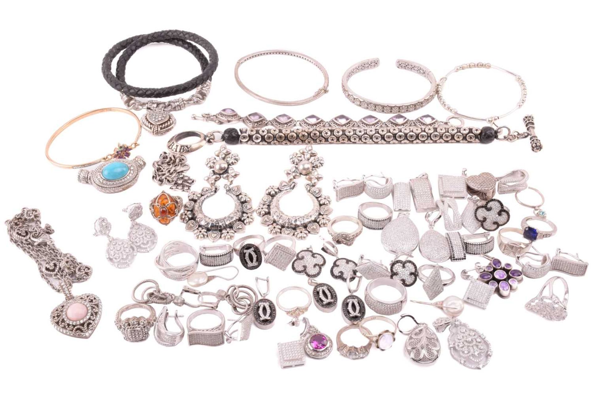 A collection of jewellery in white metal, including Thai pendants, earings and rings in white