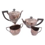 A matched Victorian and later four piece silver tea set of half fluted design, the teapot and coffee