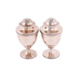 A pair of George III silver pepperettes, by John Emes, London 1805, of urn shape with reeded girdle,