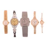 A collection of five watches including a Bulova in yellow metal stamped '750' with a case