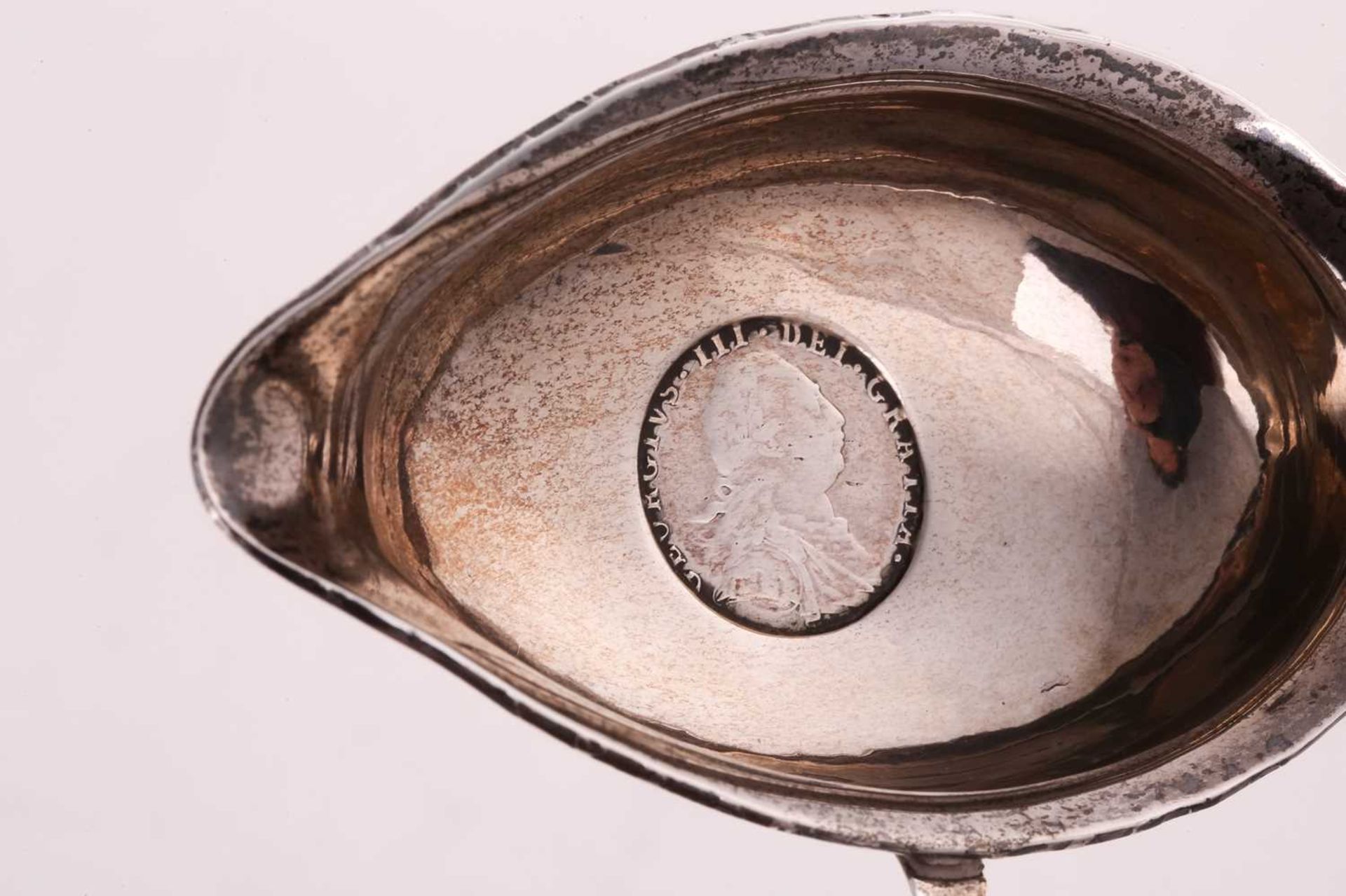 A George III white metal toddy ladle, the unassayed bowl with inset silver sixpence dated 1787, with - Image 3 of 5