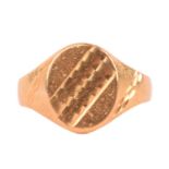 A 22ct yellow gold signet ring, the oval ring head with diagonal patterns, tapered shoulders with