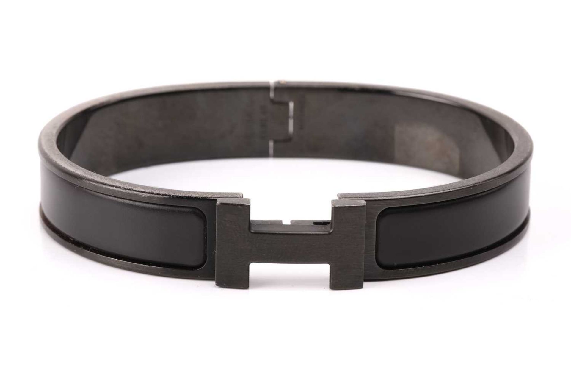 Hermès - a narrow 'Clic HH So Black' bracelet with matte enamel and plated hardware, signed and