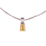 A yellow diamond pendant on an 18ct gold chain, claw-set with a tapered baguette-cut yellow
