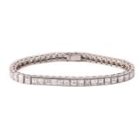 A diamond line bracelet, incorporating forty-seven graduated square step-cut diamonds channel-set in