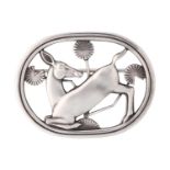 Georg Jensen - A brooch depicting kneeling fawn and flowers, fitted with hinged pin stem and roll-