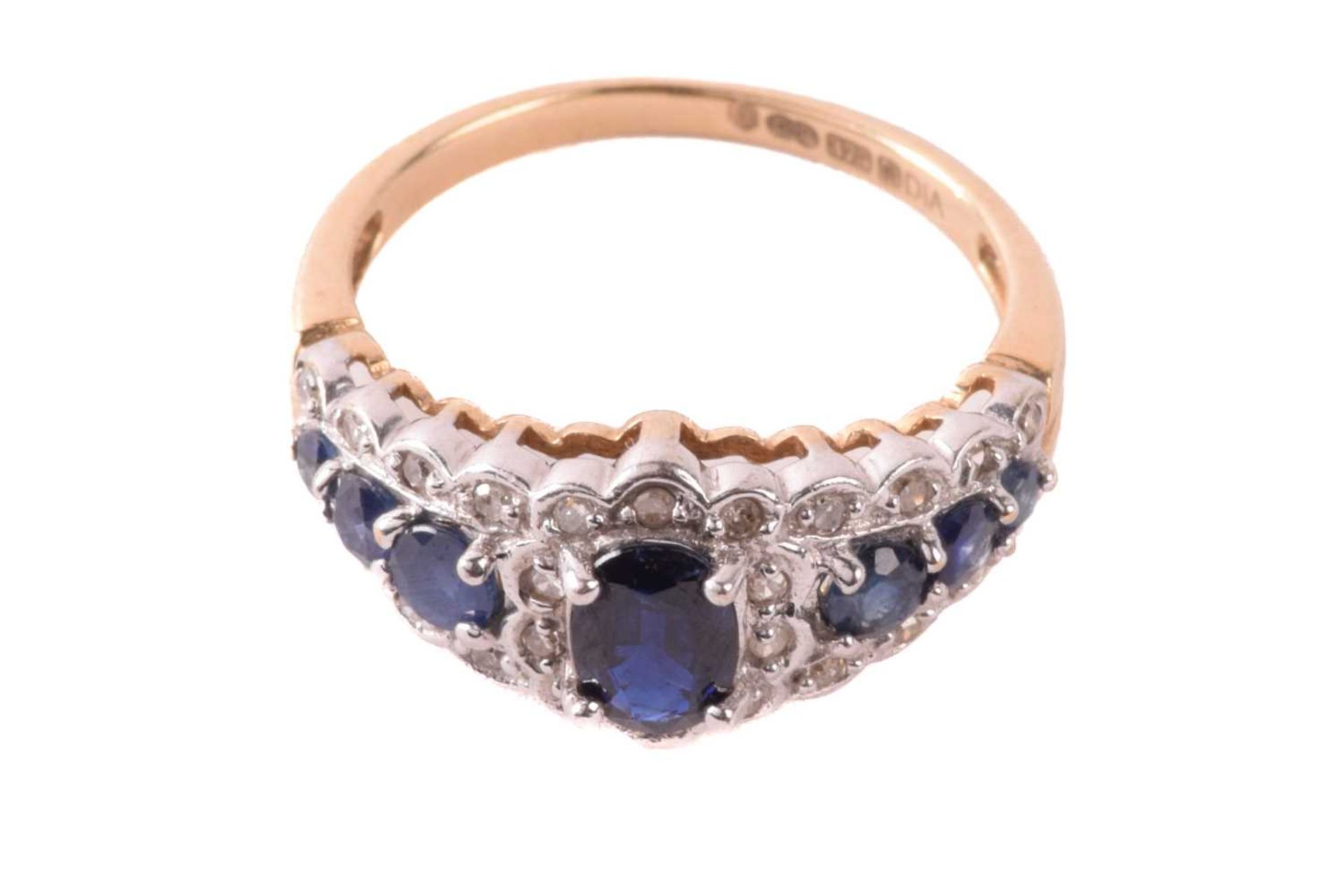 A sapphire and diamond dress ring in 9ct gold, claw-set with an oval-cut sapphire of 6.1 x 4.3 mm - Image 2 of 6