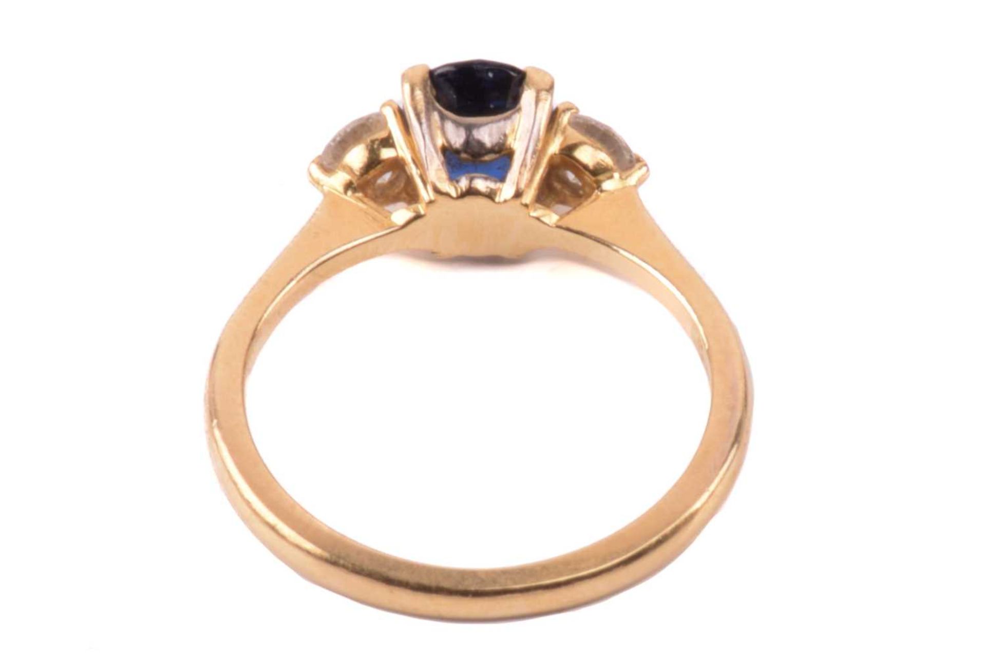 A Boodle & Dunthorne sapphire and diamond three stone ring, set with a central oval sapphire - Image 6 of 6