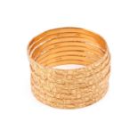 A set of eight Indian bracelets, closed bangles with bright-cut geometrical patterns all over,