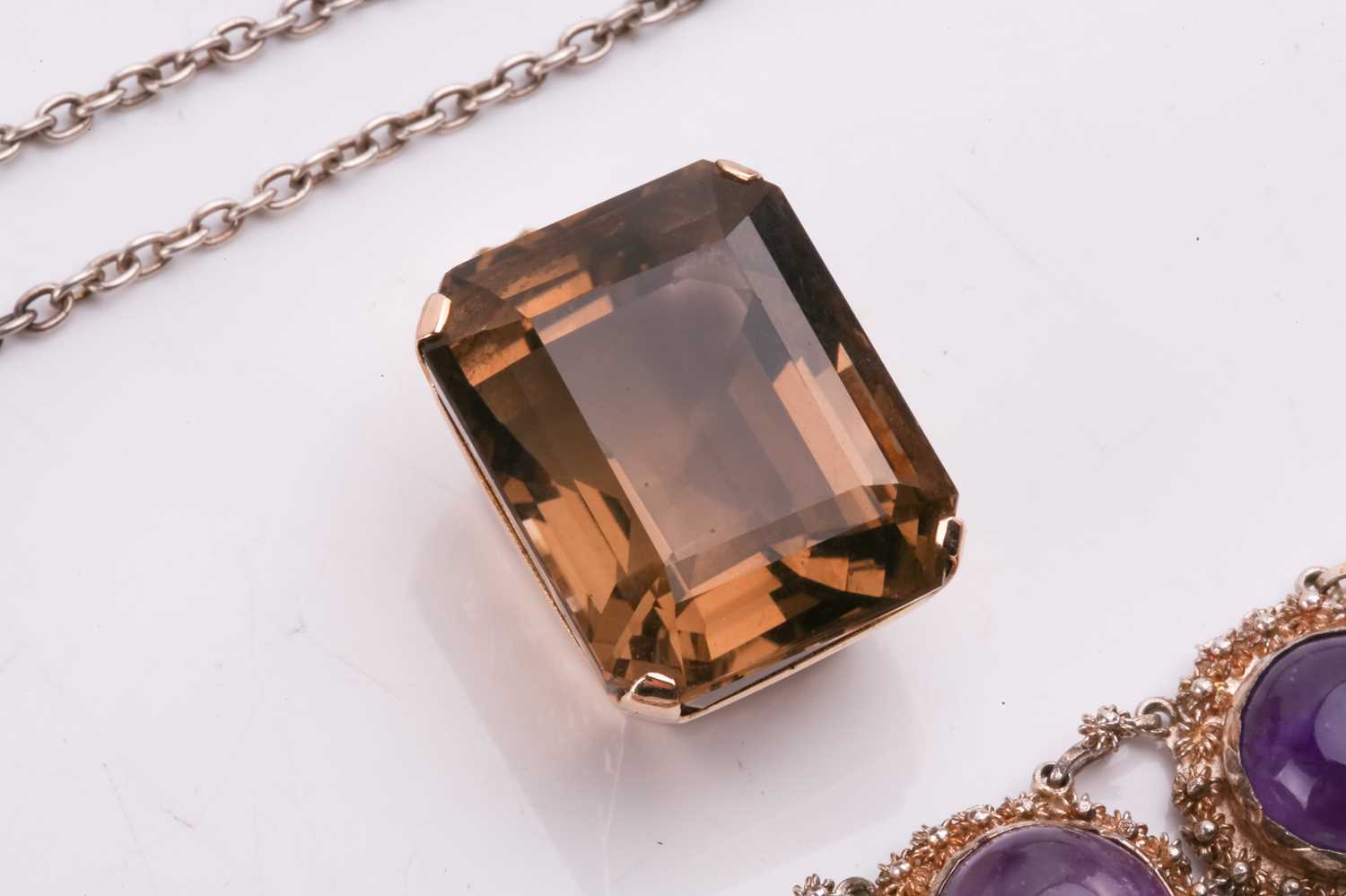 A smokey quartz pendant, the emerald cut smokey quartz measuring 25mm x 19.4mm x 15.9mm, claw set to - Image 11 of 13