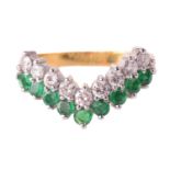 An emerald and diamond chevron ring, set with a row of emeralds and round brilliant cut diamonds