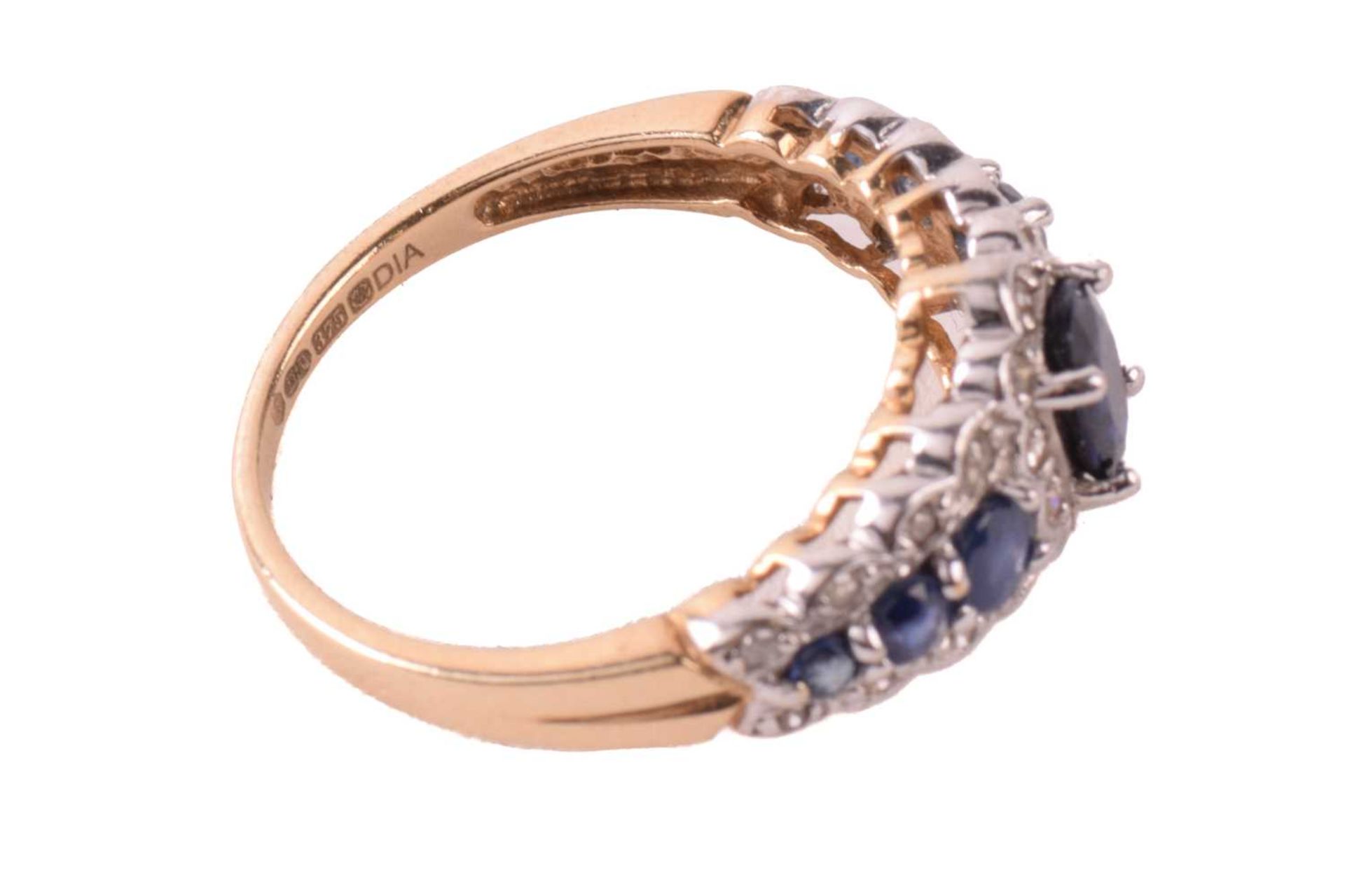 A sapphire and diamond dress ring in 9ct gold, claw-set with an oval-cut sapphire of 6.1 x 4.3 mm - Image 4 of 6