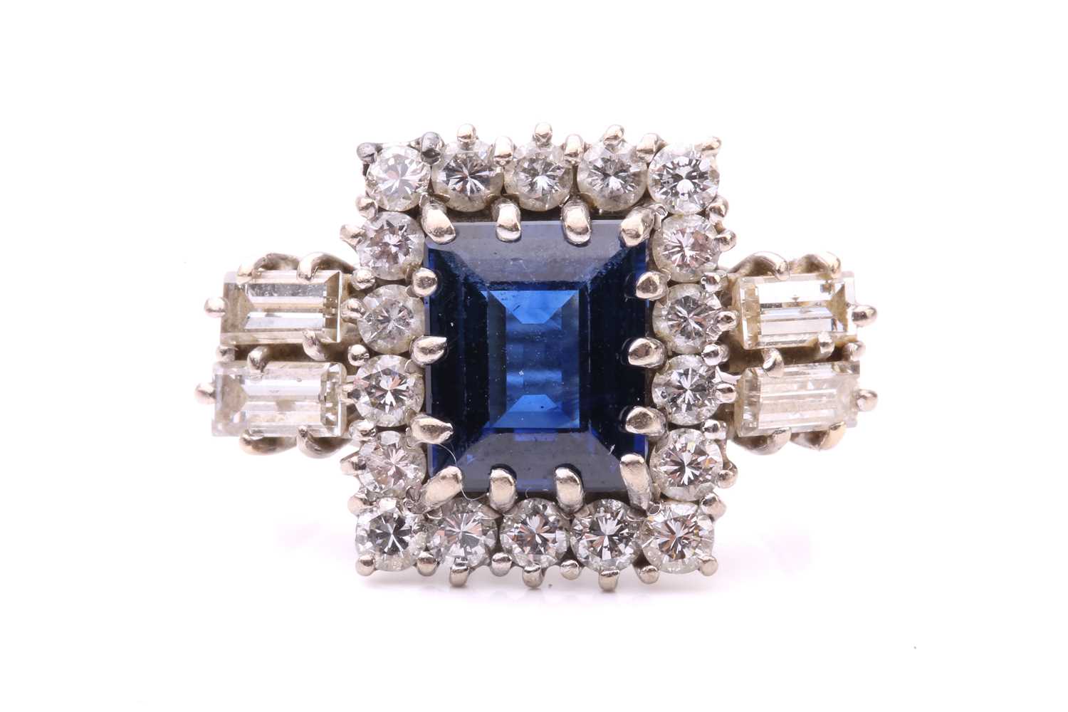 A sapphire and diamond entourage ring, featuring a rectangular step-cut sapphire of deep blue