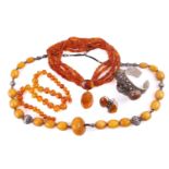 A quantity of amber jewellery items, to include three amber bead necklaces with white metal