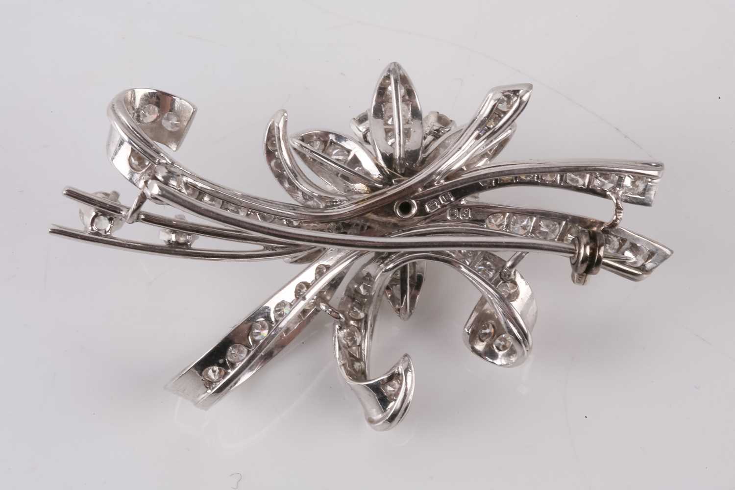 A diamond floral brooch by Cropp and Farr, circa 1961, the flower and sculptural ribbon design set - Image 2 of 3