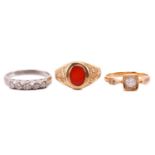 Three gem-set rings; including a carnelian signet ring in 9ct yellow gold, with an oval head and