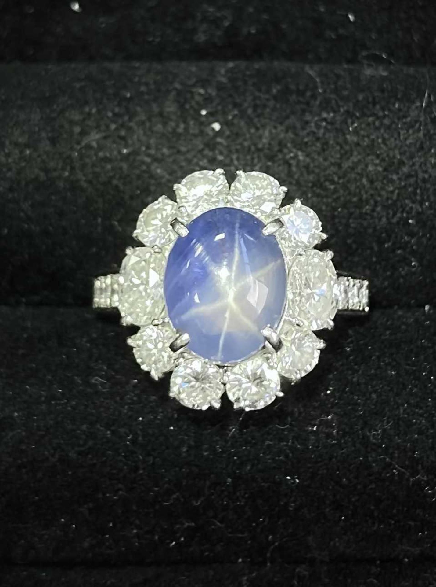 A star sapphire and diamond entourage ring, centred with a star sapphire of 9.7 x 7.7 x 6.0 mm, with - Image 2 of 6