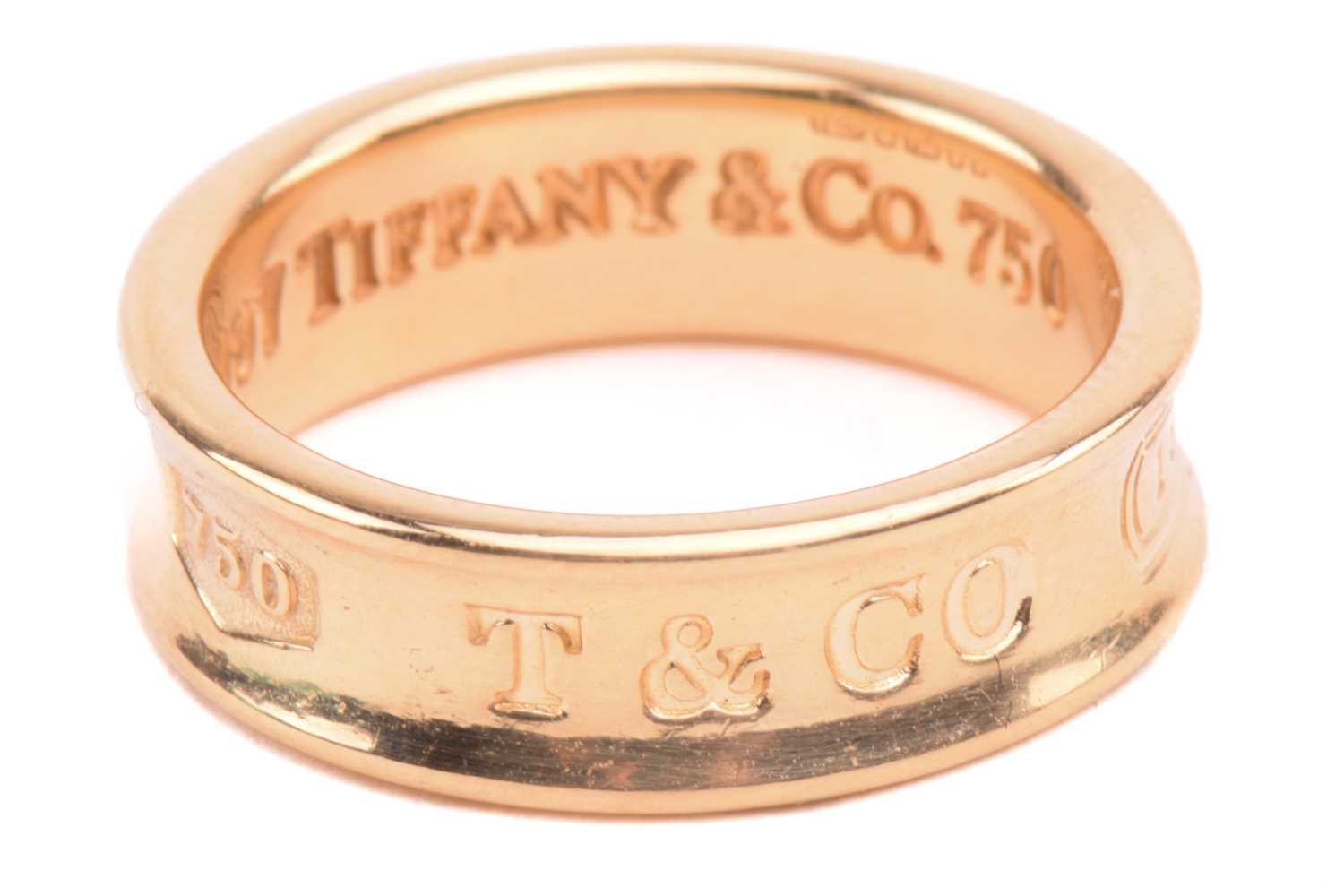 Tiffany & Co. - an 18ct yellow gold ring from the '1837' collection, the 6.1 mm wide concave band